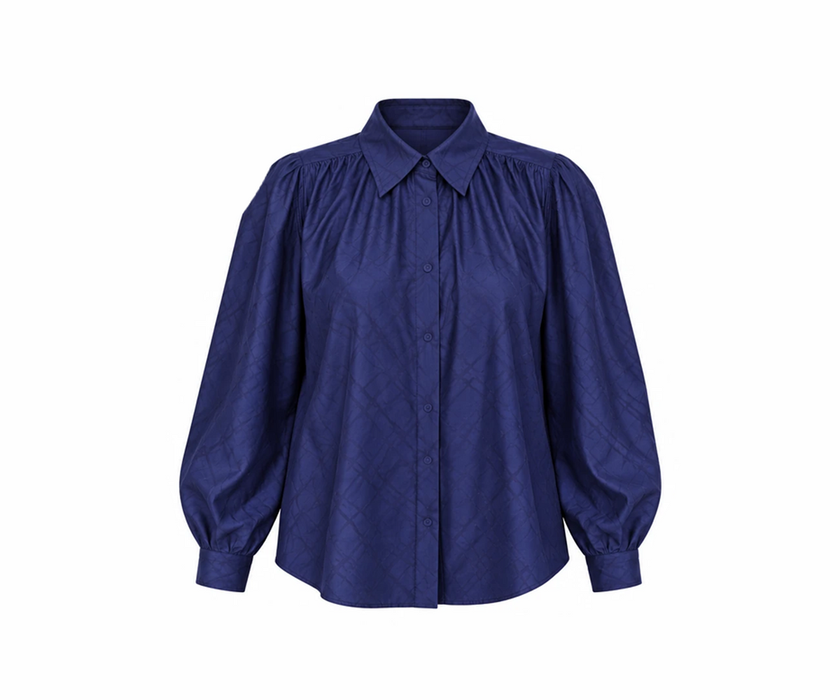 Undra Celeste New York Jane Poet Blouse in Navy, crafted from 100% Tencel with a textured finish, gathered neckline, button-front closure, voluminous dolman sleeves, and a relaxed oversized silhouette. Elegant contemporary women's workwear.