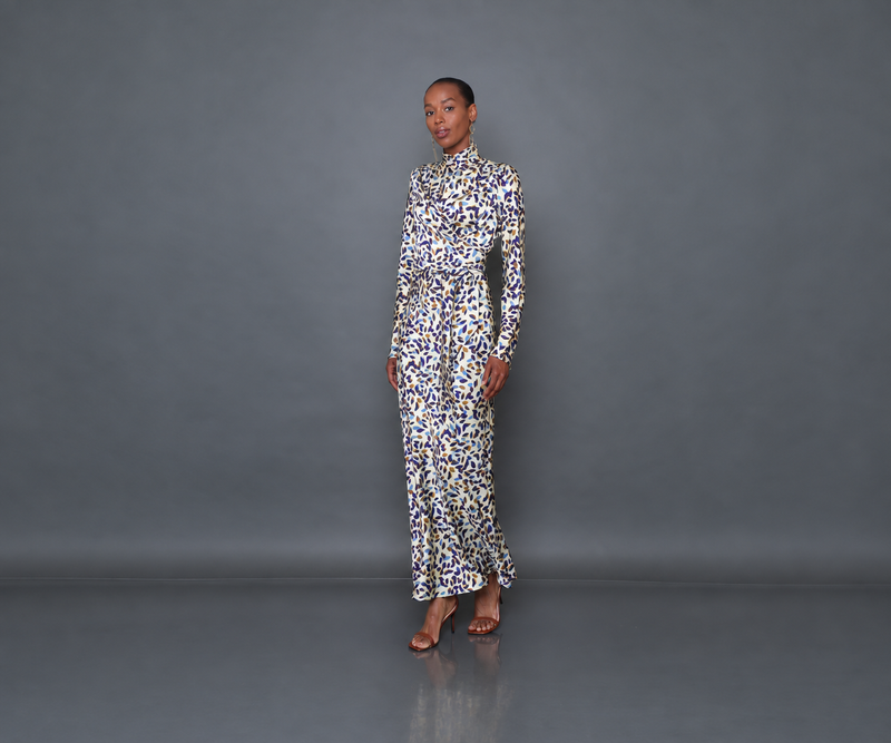 Undra Celeste New York Long Sleeve Mock Neck Joi Dress in Cream Falling Leaves print, crafted from luxurious hammered satin with a soft textured sheen, featuring a mock neckline, long flared sleeves, draped wrap-style bodice, defined waist, and flowing bias-cut maxi skirt. Sophisticated contemporary women's workwear.