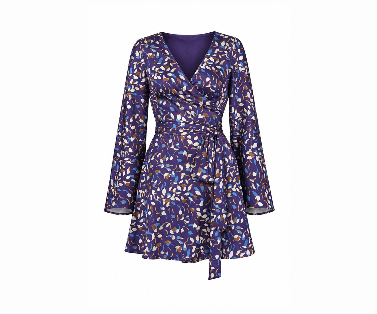 Undra Celeste New York Shonda Mini Wrap Dress in Purple Falling Leaves print, crafted from luxurious hammered satin with a deep V-neckline, long flared sleeves, adjustable wrap waist, oversized self-tie sash, and flowing mini-length skirt. Elevated contemporary women's workwear.